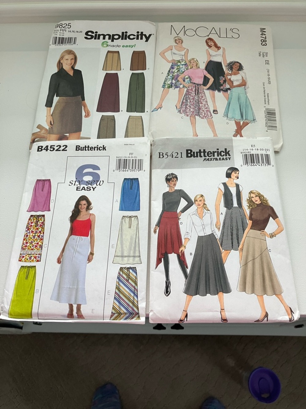 Four uncut sewing patterns all women’s skirts size 14–22